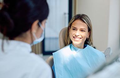 Smiling patient interacting with dental team member