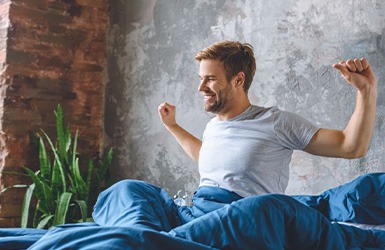 Man stretching after a good night of sleep