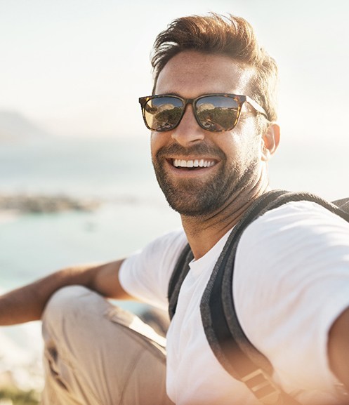 Happy, smiling man taking a selfie outdoors