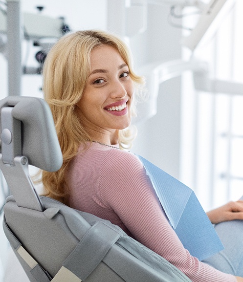 Happy dental patient looking over her shoulder