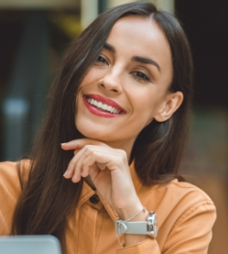 Smiling man and woman embracing against a yellow background