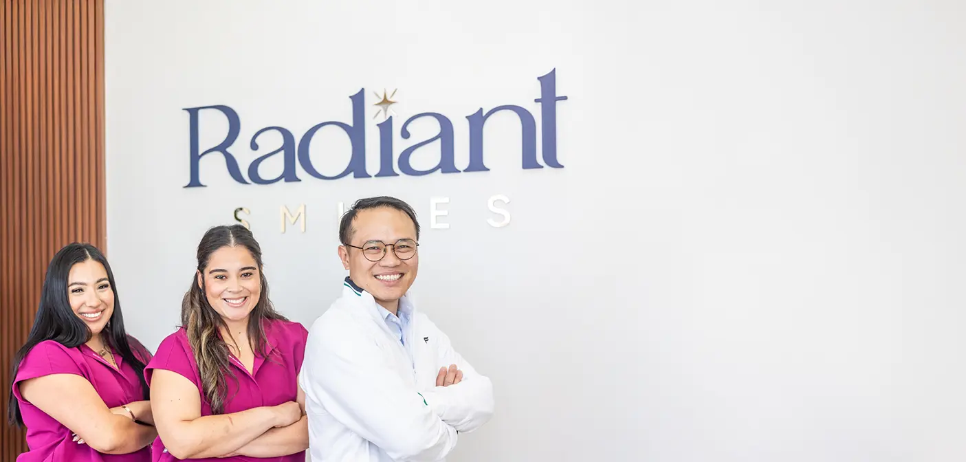 Man and woman laughing together in their living room after visiting dental office in Grand Prairie