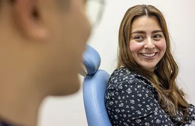 Man with short brown hair smiling in the dental chair