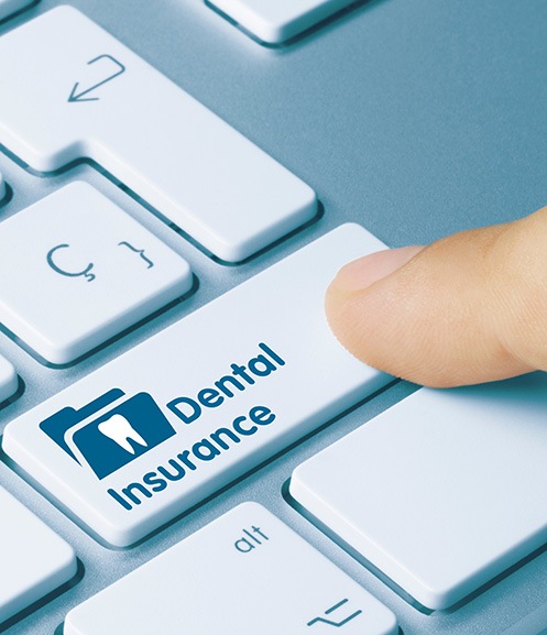 Person pressing Dental Insurance key on keyboard