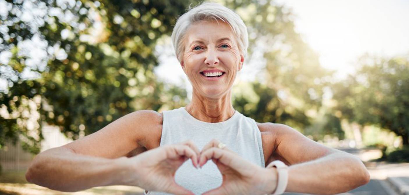 Lady makes shape of heart with her hands