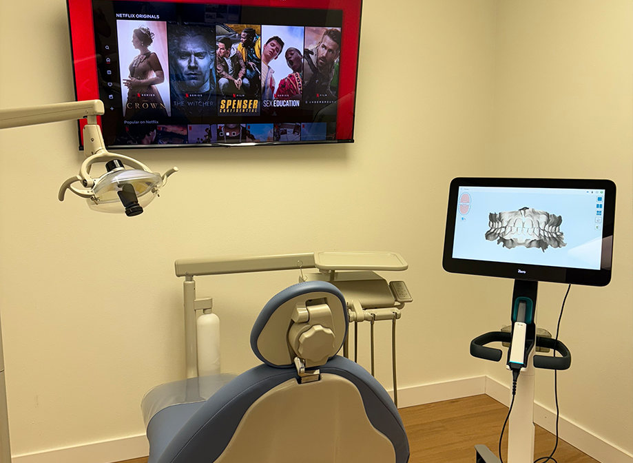 Dental treatment room with a TV mounted on the wall showing Netflix