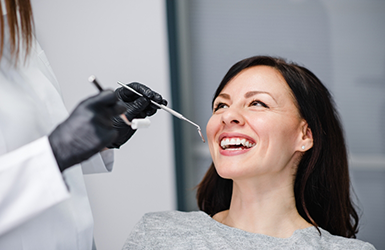 Woman grinning at her dentist during a dental checkup