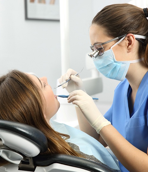Woman in dental chair undergoing dental examination