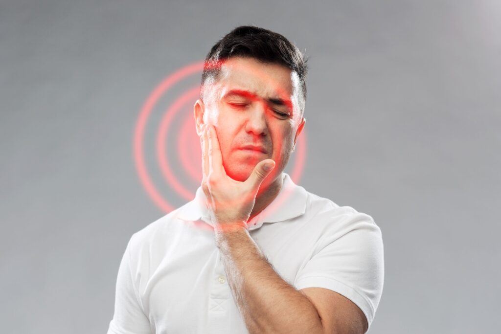 Man holding his hand to his face that's radiating orange circles