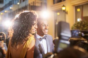 Two people smiling while they get their photo taken