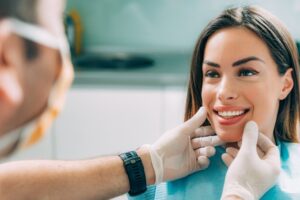 Dentist examining patient's smile.